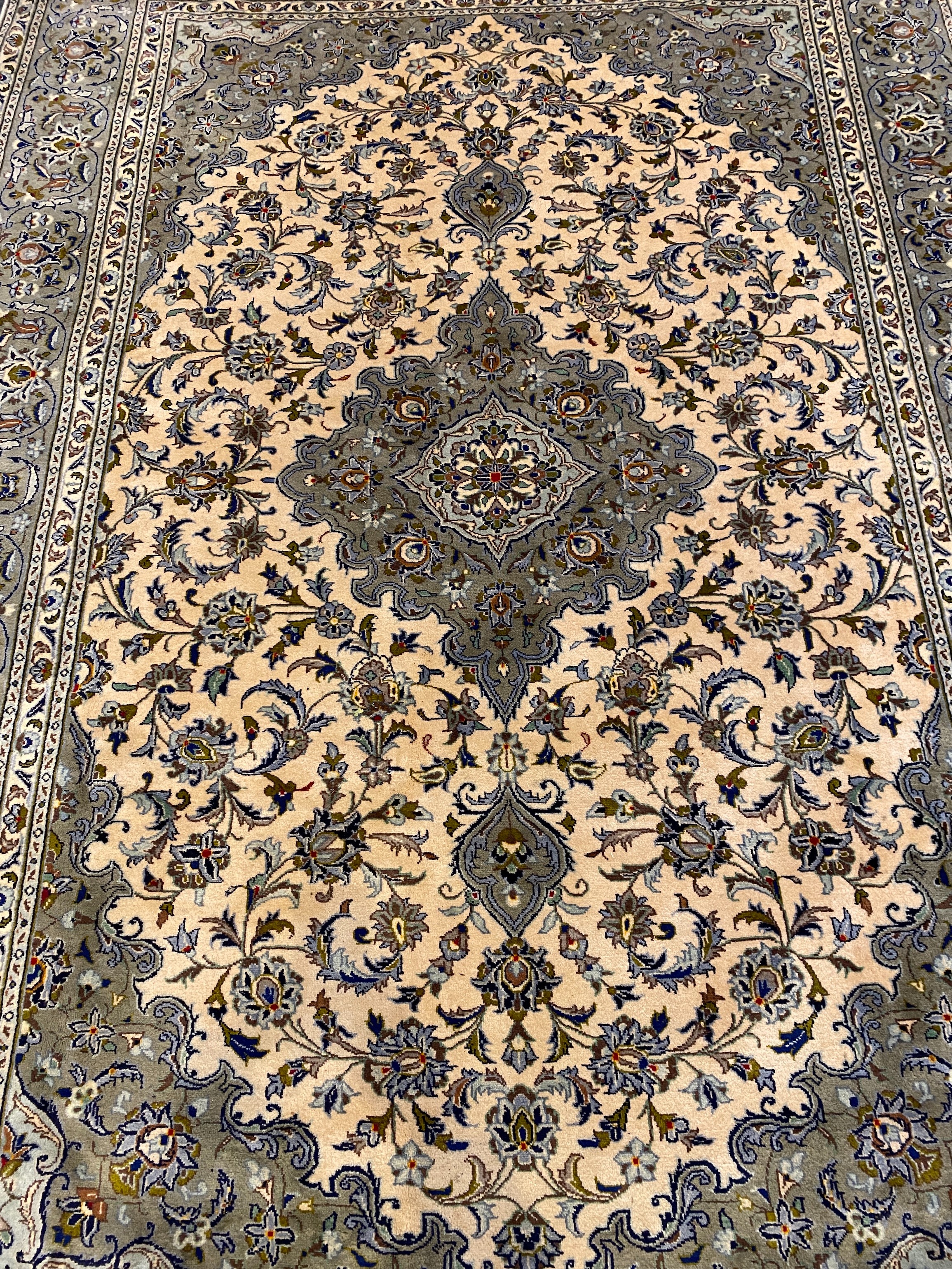 A Kashan ivory ground carpet, 355cm x 246cm